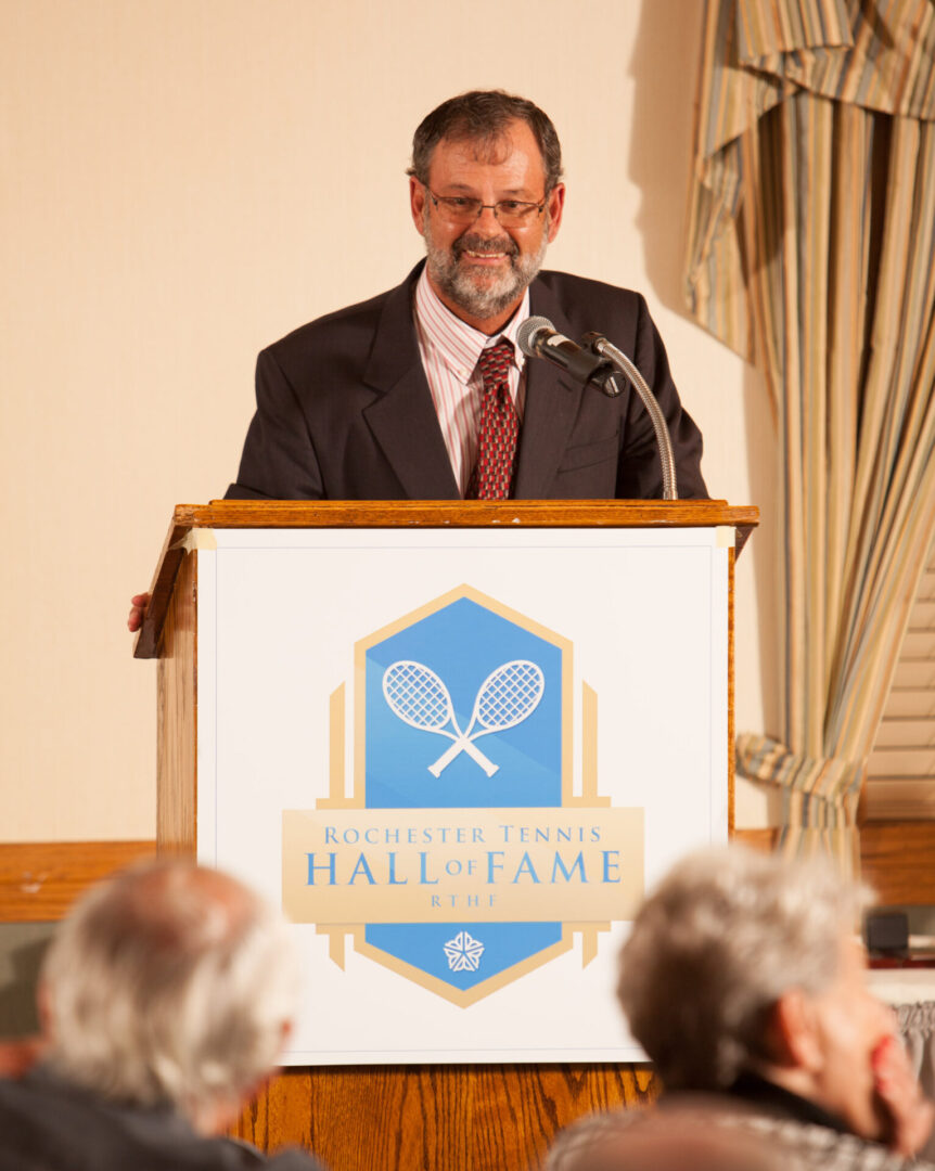 A man standing at the podium speaking to an audience.