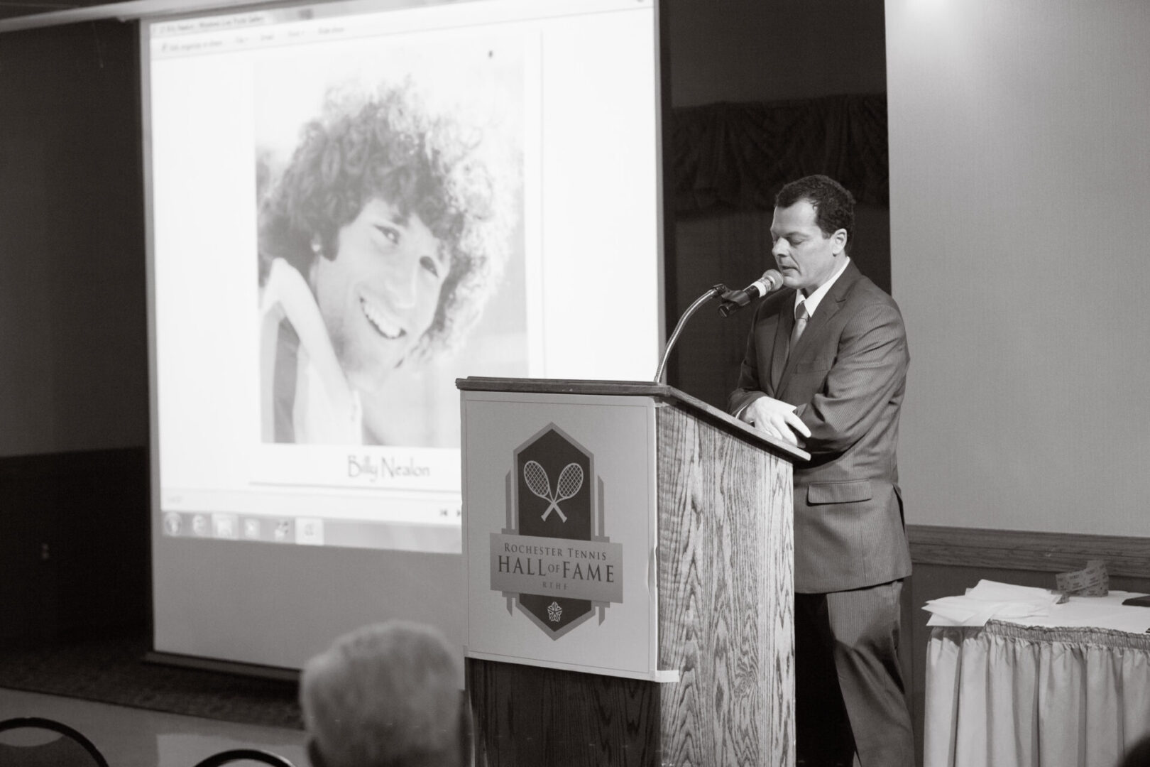 A man standing at the podium speaking to an audience.