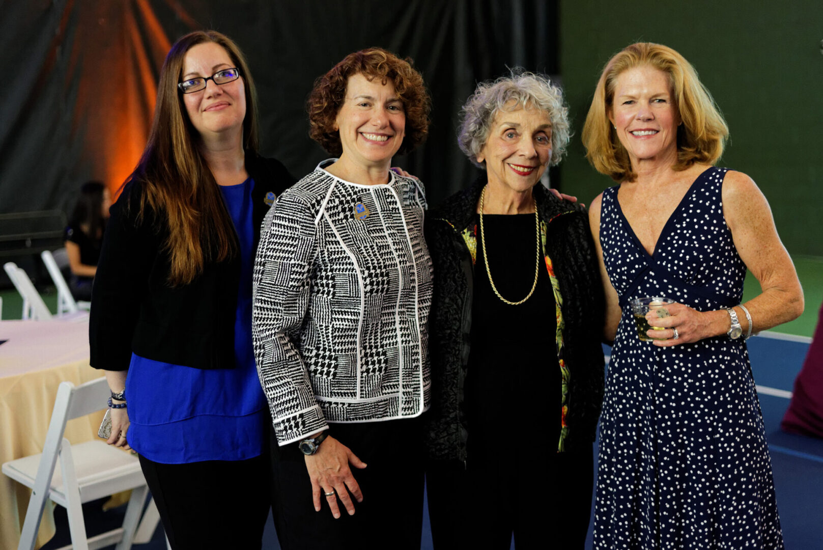 A group of women standing next to each other.