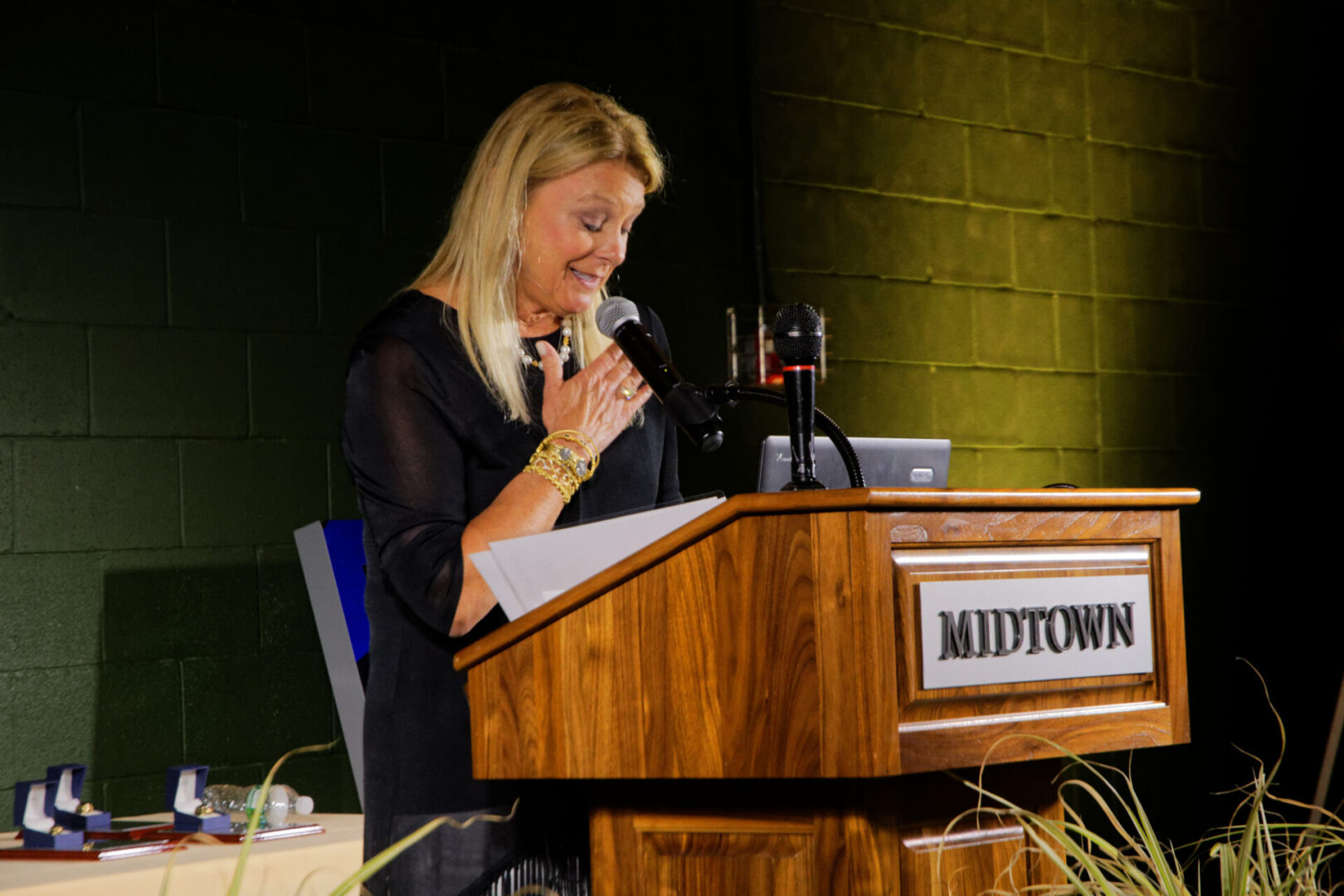 A woman is speaking at the podium of a conference.