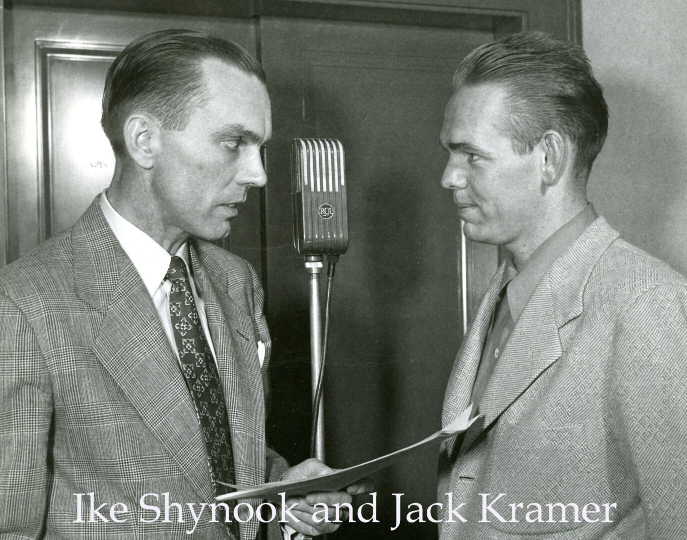 Two men in suits are talking to each other.